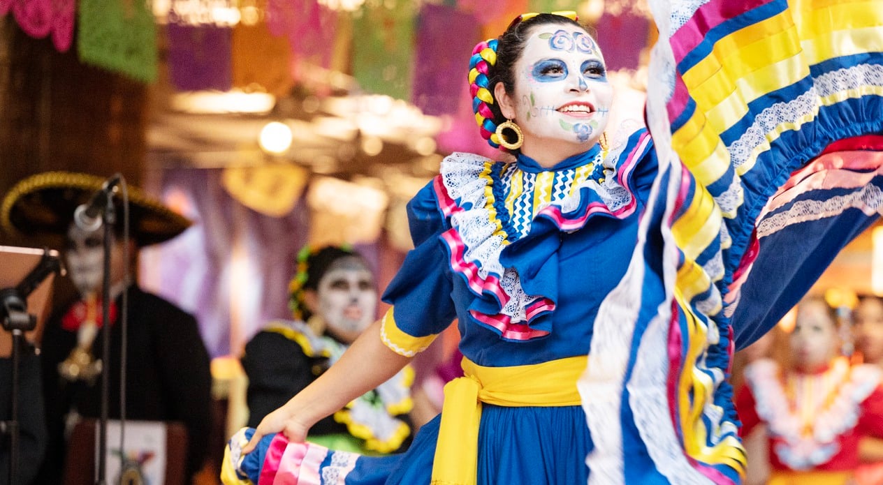 Woman dancing at dia de muertos at the museum