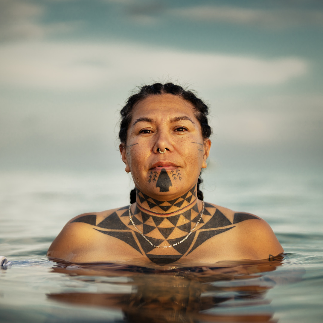 Kanahus in water with her traditional tattoos 